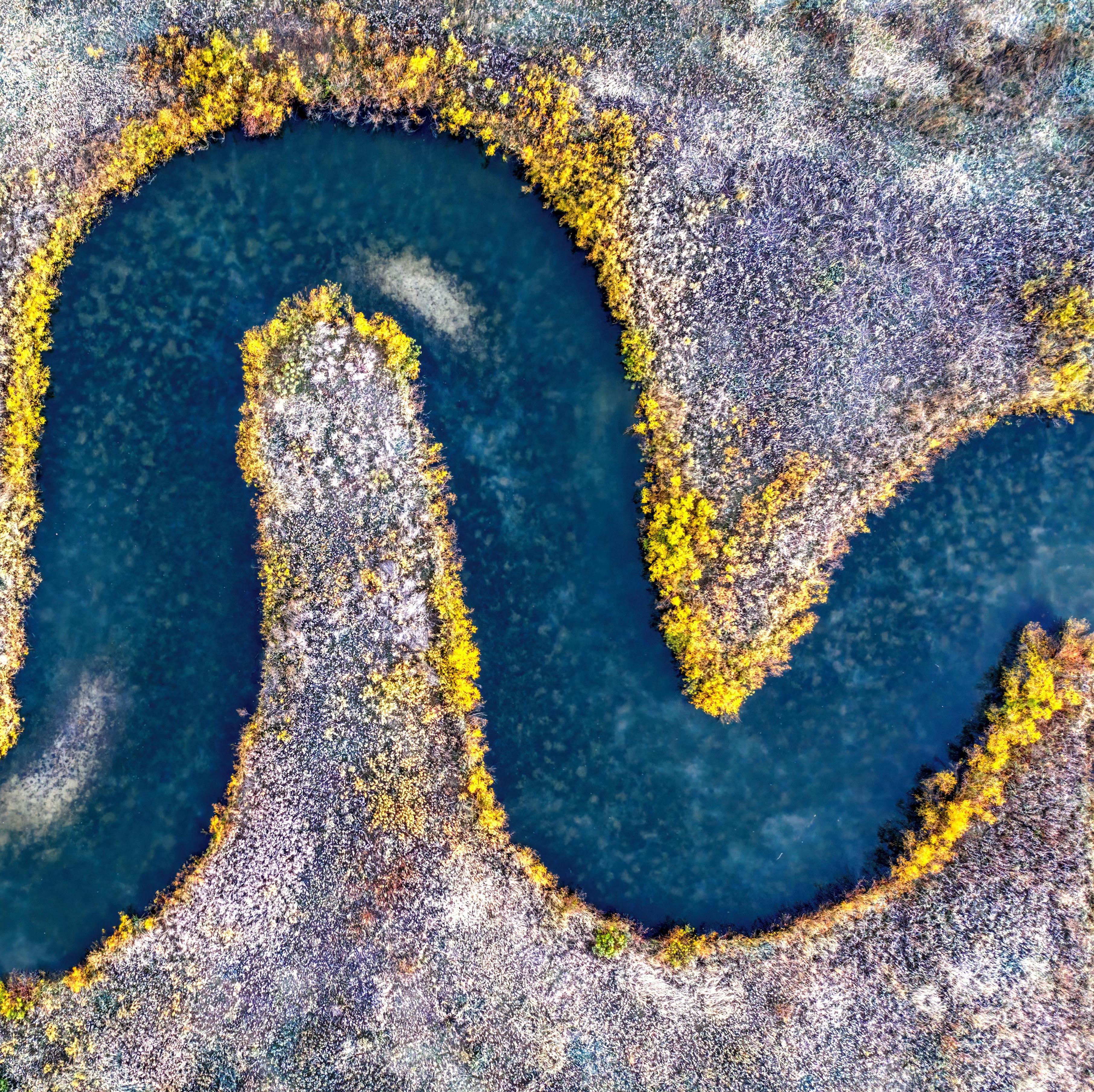 Flowing river moving around smooth stones